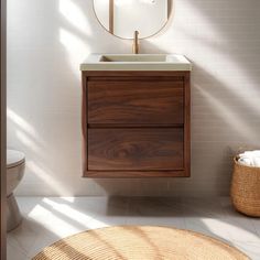 a bathroom with a sink, mirror and rug