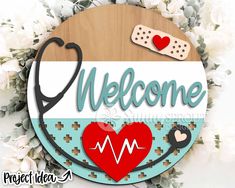 a sign that says welcome with a stethoscope and heart on it next to flowers