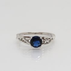 Celtic Sterling Silver Blue Sapphire Band Ring ...Marked 925...Total of weights 2.0grams...Size 8...Measure of stone 5.9MM...It's in very good condition. Blue Sapphire Sterling Silver Promise Ring, Blue Sterling Silver Round Band Jewelry, Blue Oval Sterling Silver Crystal Ring, Blue Oval Crystal Ring In Sterling Silver, Blue Sterling Silver Birthstone Ring With Round Band, Blue Sterling Silver Rings With Accent Stones, Blue Topaz Sterling Silver Ring With Round Band, Blue Topaz Ring With Sterling Silver Round Band, Classic Blue Birthstone Ring With Round Stone