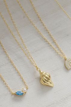 If coastal jewelry inspo is what you're looking for, you'll love Coast + Cove's Gold Ocean Necklace. It is made with 14k gold vermeil and features a stunning pearl paired with an ocean blue gemstone. This gold necklace has an adjustable design allowing for a perfect fit and making it a versatile and timeless piece for any jewelry collection. Style this as a simple everyday necklace, or layer it in a gold necklace stack.