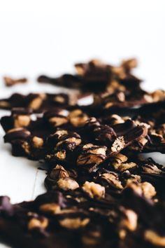 pieces of chocolate and nuts on a white surface