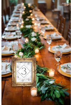 the table is set with candles and place settings