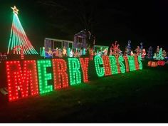 christmas lights are on display in front of a house with the word merry written across it