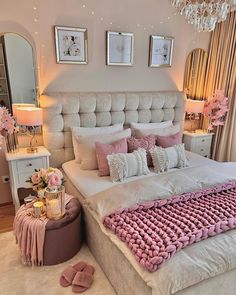 a large bed with pink and white pillows