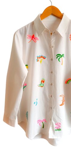 a white shirt with colorful images on it