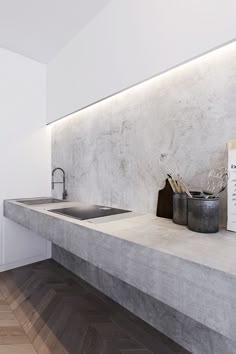 a kitchen counter with a sink and some utensils