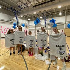 some girls are holding up t - shirts with balloons on them