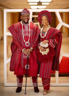 two people dressed in red standing next to each other