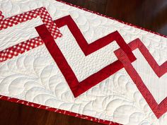 a red and white quilted table runner