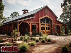 a large red barn with a clock tower on top