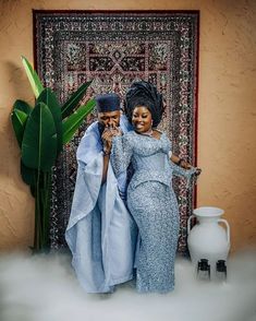 two women standing next to each other in front of a rug