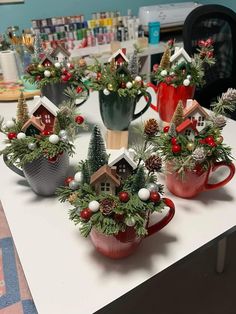 small christmas trees in mugs on a table