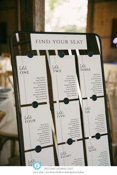 the seating chart for an event is displayed in front of a table with white linens