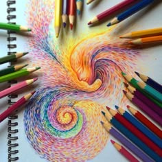 colored pencils are arranged in the shape of a spiral