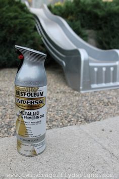 a can of rust - oleum universal metallic paint sitting on the ground next to a slide