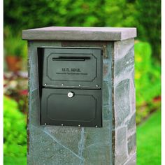 an empty mailbox in the middle of a grassy area