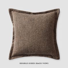 a brown pillow sitting on top of a white wall