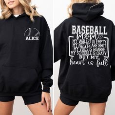 Personalized Baseball Mom Hoodie,Custom Name Baseball Hoodie,Baseball Season Hoodie,Game Day Hoodie,Sports Mom Hoodie,Custom Baseball Hoodie ### About Our Products -Youth hoodies do not include drawstrings for added safety. 🚫✨ - Our garments are crafted from a blend of 50% Cotton and 50% Polyester, ensuring both comfort and durability. - The medium-to-heavy weight fabric ensures long-lasting wear. - For your convenience, a tear-away label is included. - It provides a loose, comfortable fit that Black Hoodie With Letter Print For Game Day, Varsity Sports Hoodie With Letter Print, Fleece Hoodie With Letter Print For Sports Events, Black Long Sleeve Sports Fan Hoodie, Game Day Hoodie Sweatshirt With Letter Print, Sports Season Hoodie With Letter Print For Sports Events, College Sports Fan Hoodie With Letter Print, Sports Fan College Hoodie With Letter Print, Long Sleeve Sports Hoodie For Baseball Season