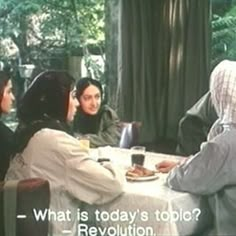 a group of people sitting at a table talking to each other with the caption what is today's topic revolution?