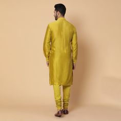 A very unique 3 paneled kurta with embroidery of an umbrella inspired from a chariot. Same color cotton lycra churidar Fabric- cotton chanderi, raw silk. Yellow is a bright and playful color, this outfit is perfect for a groom or as a brother of the bride or groom. Can be worn for Sangeet or Mehandi for a day or night event. Delivery: 20 Days Diwali Straight Kurta Sherwani In Slub Silk, Slub Silk Straight Kurta Sherwani For Festivals, Yellow Long Sleeve Raw Silk Kurta, Eid Cotton Silk Straight Kurta, Fitted Yellow Cotton Silk Kurta, Eid Cotton Silk Bandhgala Straight Kurta, Cotton Silk Bandhgala For Designer Wear, Yellow Cotton Silk Churidar For Diwali, Diwali Slub Silk Long Sleeve Churidar