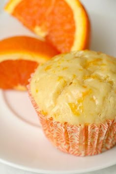 a muffin sitting on top of a white plate next to an orange