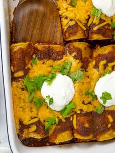 an enchilada casserole with sour cream and cilantro