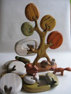 a group of wooden toys sitting on top of a white table next to each other