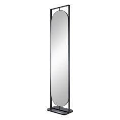 a tall black mirror sitting on top of a metal stand next to a white wall