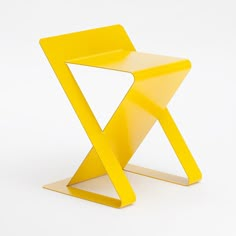 a yellow chair sitting on top of a white floor