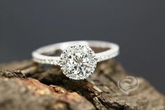 a diamond ring sitting on top of a piece of wood