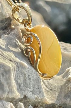 Pendant material and details : * White landscape Amber and Gold-plated Sterling Silver  * Stone : Natural Baltic Amber * Silver hallmark :Ag 925 * Pendant length : 5,5 cm * Pendant width: 3,5cm * Pendant weight: 13,0  g *Color :  White , Yellow Handmade Yellow Baltic Amber Necklaces, Oval Baltic Amber Necklace, Handmade Baltic Amber Necklace In Yellow, Handmade Yellow Baltic Amber Necklace, Luxury Amber Cabochon Jewelry, Oval Baltic Amber Gold Jewelry, Gold Baltic Amber Round Necklace, Gold Baltic Amber Necklace, Classic Handmade Amber Necklaces