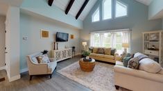 a living room filled with furniture and a flat screen tv on top of a wooden stand