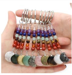 a hand holding a bunch of different colored beads