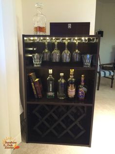 a bookcase filled with liquor bottles and glasses