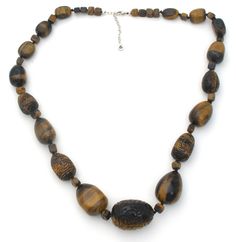 Statement Jewelry - This is a substantial vintage knotted brown tiger's eye sterling silver necklace with fabulous hand carved beads. It is 30" long, which includes the 2.5" extension, so necklace can be worn from 27.5" to 30" in length. Beads are hand knotted and vary from slightly over .25" to 1.25" in diameter. It is hallmarked 925, weighs 300 grams and signed Barse. Brown Necklaces With Polished Oval Beads, Brown Jewelry With Oval Wooden Beads, Brown Wooden Beads Oval Jewelry, Brown Wooden Oval Beads Jewelry, Brown Single Strand Necklace, Brown Oval Beaded Necklaces Hand-strung, Brown Oval Beaded Hand-strung Necklaces, Brown Oval Beaded Hand-strung Necklace, Hand-strung Brown Jewelry With Oval Beads