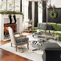 a living room filled with furniture and a fire place in front of a christmas tree