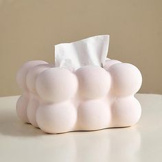 a tissue dispenser sitting on top of a table