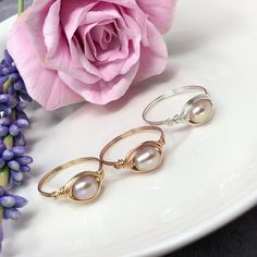 These gorgeous rings are created with ultra fine, freshwater pearls in sophisticated oval shape. The tints in the pearls are a blend of soft peach with hints of a lavender opalescence. So exquisitely unique and beautiful! Handcrafted in your choice of 14kt yellow gold filled, 14kt rose gold filled or sterling silver. The dainty, double band has a feminine touch of petite spiral detailing on each side of the pearl. This is an amazing gift for a loved one or for yourself! -AAA peach-lavender, fres Rose Gold Pearl Ring, Pearl Ring Gold, Peach Lavender, Bridesmaid Ring, Gorgeous Rings, Silver Pearl Ring, Bridesmaid Rings, Gold Pearl Ring, Rose Gold Pearl