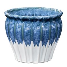 a blue and white vase sitting on top of a table