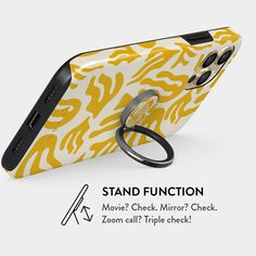 a yellow and white cell phone case with a ring on the cover that says stand function move's check mirror check zoom call triple check