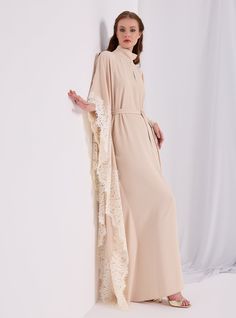 WF ATELIER Model height: 177 CM 100% Polyester Length: 140cm Elegant Flowy Spring Abaya, Spring Dress With Cape Sleeves, Cream Long Evening Dress, Long Cream Evening Dress, Elegant Beige Tunic Maxi Dress, Elegant Long Beige Kaftan, Elegant Beige Maxi-length Kaftan, Elegant Beige Maxi Length Kaftan, Flowy Beige Dress