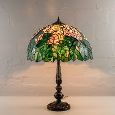 Category: Stained Glass Lamps Stained glass Tiffany lamp with green leaves and white flowers is a perfect item of home decor, as these calming colors will definitely make the atmosphere at your place of living more relaxing. At the same time this lamp will make your room more stylish! Measurements: 24,8 x 16,3 inch (630 x 415 mm) ⠀ In the process of stained glass lamps manufacturing, we refer to the method of copper foil suggested by L.C. Tiffany. We use only the high-quality materials, such as:• 3 mm Spectrum Glass • 3 mm Wissmach Glass • 3 mm Uroboros Glass • Tin• Copper Foil• Black Patina• Wax ⠀ All stained glass lamps should be wiped with a wet piece of cloth only. ⠀ Each stained lamp is safely packed into a brand box for delivering it to our customers safe and sound. _________________ Tiffany Lamp Shade, Spectrum Glass, Stained Glass Lamp, Tiffany Style Lamp, Tiffany Lamp, Cute Furniture, Lights Bedroom, Stained Glass Lamps, Grunge Room