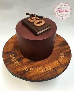 a birthday cake with the number sixty on it and a book sitting on top of it