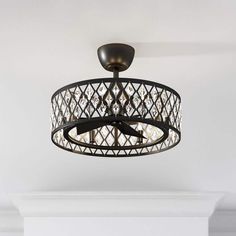 a chandelier hanging from the ceiling in a room with white walls and flooring