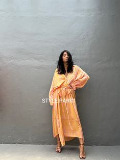 Jimbaran dress  is an oversized long sleeve soft rayon voile Long shirts  dress  .  This Oversized shirt dress is designed to flatter every body type and fit numerous occasions. 👍Included tali - f e a t u r e s - - Relaxed fit - Front pockets Fabric: 100% Soft rayon voile  Style:oversized fit Color:Bali Hand tie dyed peach & multi motif Wash :Hand cool wash  - measurement -  - One size  -  I recommend American size M to XL Chest /164cm/ 64inch(round) Length/135cm/53inch Transparent - it's  tran Bohemian Long Sleeve Floral Dress For Summer, Oversized Long Sleeve Maxi Dress For Vacation, Orange Long Sleeve Bohemian Maxi Dress, Orange Bohemian Long Sleeve Maxi Dress, Yellow Long Sleeve Casual Tunic, Oversized Long Sleeve Maxi Dress For Day Out, Flowy Long Sleeve Dresses For Beach Cover-up, Yellow Long Oversized Dresses, Oversized Long Sleeve Tunic For Beach Cover-up