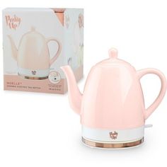 a pink tea kettle next to a box