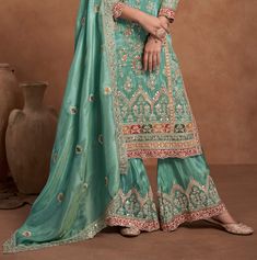 COLOR : Sea Green FABRIC : Top, Bottom, Dupatta - Fancy Silk WORK : Zari Embroidery, Sequins, Resham Work, Foil Mirror Work, Embellished Border OCCASION : Wedding, Party Wear, Festival READY-TO-WEAR : No STITCHING : Available as semi-stitched fabric, can be stitched using standard size option (+$30). Note: There might be a slight color variation due to lighting and flash used during photoshoot. The bright shade seen is the best closer view of fabric's color. Resham Work, Zari Embroidery, Wedding Party Wear, Palazzo Suit, Mirror Work, Sea Green, Green Fabric, Salwar Suits, The Outfit