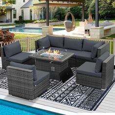 an outdoor patio furniture set sitting on top of a rug next to a swimming pool