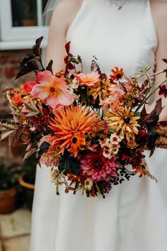 a bride holding a bouquet of flowers in her hands