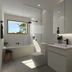 a white bathroom with a toilet, sink and bathtub in front of a window